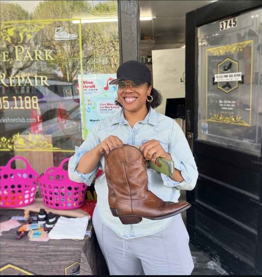 Customer with boots outside College Park Shoe Repair